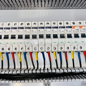Close-up of an organized circuit breaker panel featuring color-coded electrical wiring.