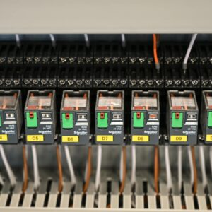 Close-up view of electrical relays in an industrial panel box showcasing circuit components.
